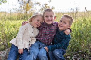 Littleton family photographer McCabe Meadows Colorado sunset photography twins kids mother father son daughter river bridge siblings brothers sister