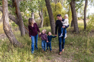 Littleton family photographer McCabe Meadows Colorado sunset photography twins kids mother father son daughter river bridge siblings walking woods trees