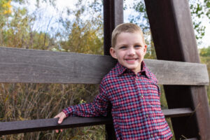 Littleton family photographer McCabe Meadows Colorado sunset photography twins kids mother father son daughter river bridge boy brother