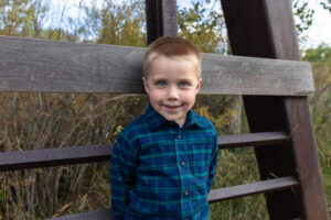 Littleton family photographer McCabe Meadows Colorado sunset photography twins kids mother father son daughter river bridge brother
