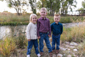 Littleton family photographer McCabe Meadows Colorado sunset photography twins kids mother father son daughter river bridge siblings
