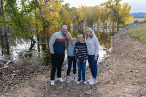 Littleton family photographer fall leaves Chatfield State Park Colorado color photography sunset siblings brother sister mother father daughter son