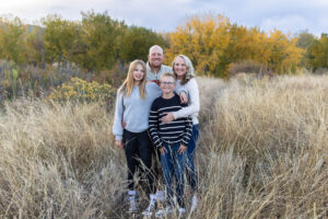 Littleton family photographer fall leaves Chatfield State Park Colorado color photography sunset siblings brother sister mother father daughter son