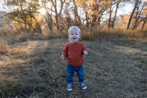 Littleton family photographer Hildebrand Ranch fall Colorado sunset photography baby boy mother father son foothills leaves