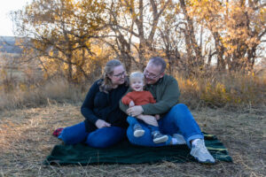 Littleton family photographer Hildebrand Ranch fall Colorado sunset photography baby boy mother father son foothills leaves