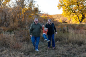 Littleton family photographer Hildebrand Ranch fall Colorado sunset photography baby boy mother father son foothills leaves