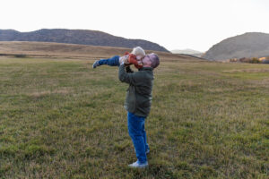 Littleton family photographer Hildebrand Ranch fall Colorado sunset photography baby boy mother father son foothills leaves