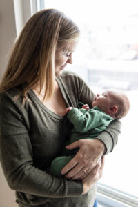 Littleton family and newborn baby photographer in home lifestyle brother infant mother father son photography