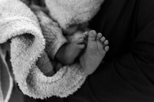 Littleton family photographer newborn baby infant lifestyle photo session in home siblings sisters brothers mother father daughter natural light Colorado photography