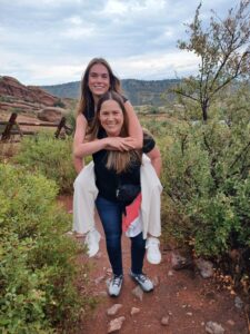 Littleton high school senior photographer Red Rocks mother daughter rain piggy back ride Colorado photography