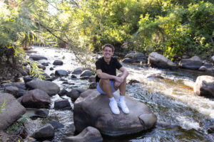 Littleton high school senior photographer sunrise photo session in Colorado Heritage ski cars swim team college bound sun Morrison photography Mt. Falcon park teenager river rock