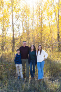 Littleton family photographer Lair O' the Bear park in Morrison Colorado yellow fall leaves trees mother father son daughter brother sister photography river bridge