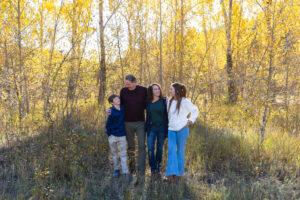 Littleton family photographer Lair O' the Bear park in Morrison Colorado yellow fall leaves trees mother father son daughter brother sister photography river bridge