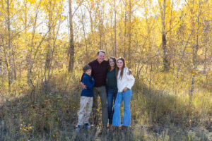 Littleton family photographer Lair O' the Bear park in Morrison Colorado yellow fall leaves trees mother father son daughter brother sister photography river bridge