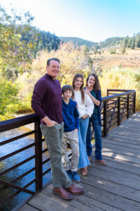 Littleton family photographer Lair O' the Bear park in Morrison Colorado yellow fall leaves trees mother father son daughter brother sister photography river bridge