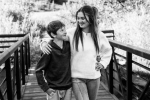 Littleton family photographer Lair O' the Bear park in Morrison Colorado yellow fall leaves trees mother father son daughter brother sister photography river bridge
