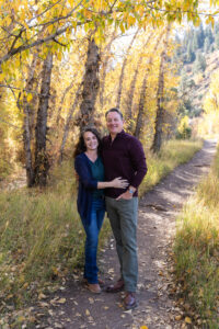 Littleton family photographer Lair O' the Bear park in Morrison Colorado yellow fall leaves trees mother father son daughter brother sister photography river bridge