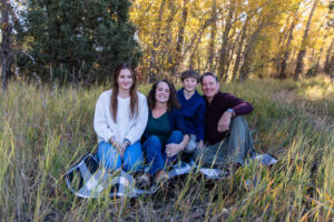 Littleton family photographer Lair O' the Bear park in Morrison Colorado yellow fall leaves trees mother father son daughter brother sister photography river bridge