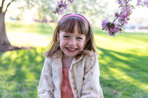 Littleton family photographer Colorado mini session photography pink and white trees sunset spring mother father daughters girls church