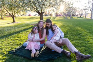 Littleton family photographer Colorado mini session photography pink and white trees sunset spring mother father daughters girls church