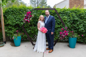 Littleton wedding photographer Colorado photography backyard ceremony flowers homemade arch kids family rain storm severe weather vows bride and groom