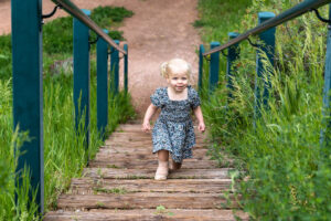 Littleton family photographer Morrison park mother father daughter little girl photography Colorado bridge river