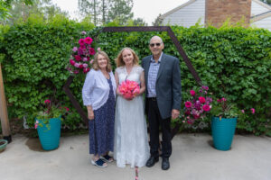 Littleton wedding photographer Colorado photography backyard ceremony flowers homemade arch kids family rain storm severe weather vows bride and groom