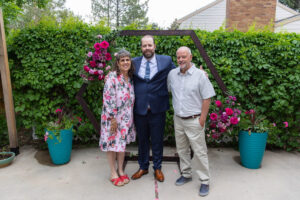 Littleton wedding photographer Colorado photography backyard ceremony flowers homemade arch kids family rain storm severe weather vows bride and groom