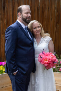 Littleton wedding photographer Colorado photography backyard ceremony flowers homemade arch kids family rain storm severe weather vows bride and groom
