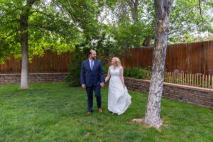 Littleton wedding photographer Colorado photography backyard ceremony flowers homemade arch kids family rain storm severe weather vows bride and groom