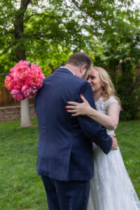 Littleton wedding photographer Colorado photography backyard ceremony flowers homemade arch kids family rain storm severe weather vows bride and groom