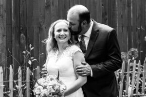 Littleton wedding photographer Colorado photography backyard ceremony flowers homemade arch kids family rain storm severe weather vows bride and groom