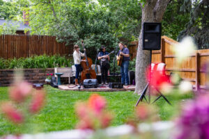 Littleton wedding photographer Colorado photography backyard ceremony flowers homemade arch kids family rain storm severe weather vows bride and groom