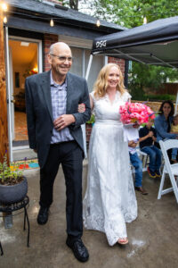 Littleton wedding photographer Colorado photography backyard ceremony flowers homemade arch kids family rain storm severe weather vows bride and groom