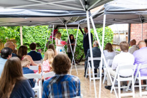 Littleton wedding photographer Colorado photography backyard ceremony flowers homemade arch kids family rain storm severe weather vows bride and groom