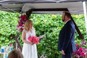 Littleton wedding photographer Colorado photography backyard ceremony flowers homemade arch kids family rain storm severe weather vows bride and groom