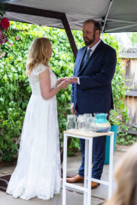 Littleton wedding photographer Colorado photography backyard ceremony flowers homemade arch kids family rain storm severe weather vows bride and groom
