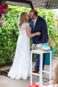 Littleton wedding photographer Colorado photography backyard ceremony flowers homemade arch kids family rain storm severe weather vows bride and groom
