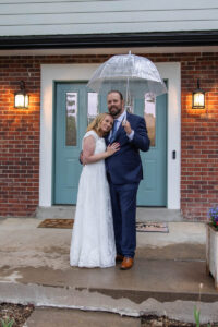Littleton wedding photographer Colorado photography backyard ceremony flowers homemade arch kids family rain storm severe weather vows bride and groom