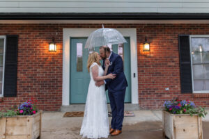 Littleton wedding photographer Colorado photography backyard ceremony flowers homemade arch kids family rain storm severe weather vows bride and groom