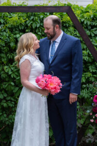 Littleton wedding photographer Colorado photography backyard ceremony flowers homemade arch kids family rain storm severe weather vows bride and groom