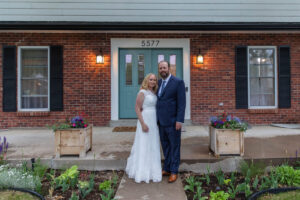 Littleton wedding photographer Colorado photography backyard ceremony flowers homemade arch kids family rain storm severe weather vows bride and groom