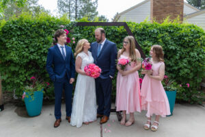 Littleton wedding photographer Colorado photography backyard ceremony flowers homemade arch kids family rain storm severe weather vows bride and groom
