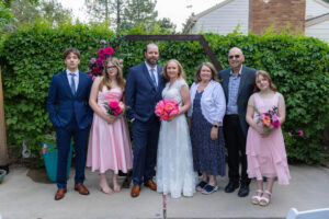 Littleton wedding photographer Colorado photography backyard ceremony flowers homemade arch kids family rain storm severe weather vows bride and groom