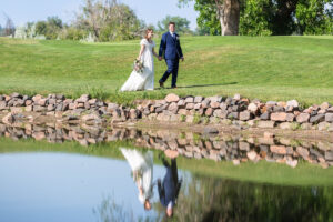 Littleton wedding photographer golf course Colorado photography lake water reflection bride groom married marriage reception ceremony
