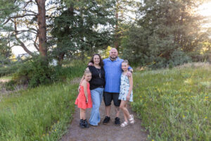 Littleton family photographer Mt. Falcon park Colorado sunset golden hour sisters photography mountain views mother father daughters wildflowers 