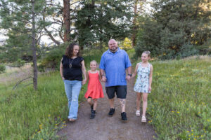 Littleton family photographer Mt. Falcon park Colorado sunset golden hour sisters photography mountain views mother father daughters wildflowers 
