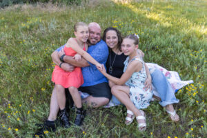 Littleton family photographer Mt. Falcon park Colorado sunset golden hour sisters photography mountain views mother father daughters wildflowers 