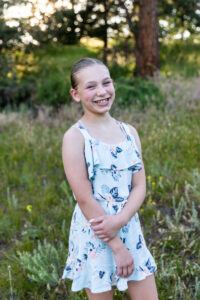 Littleton family photographer Mt. Falcon park Colorado sunset golden hour sisters photography mountain views mother father daughters wildflowers 