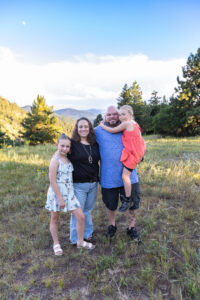 Littleton family photographer Mt. Falcon park Colorado sunset golden hour sisters photography mountain views mother father daughters wildflowers 